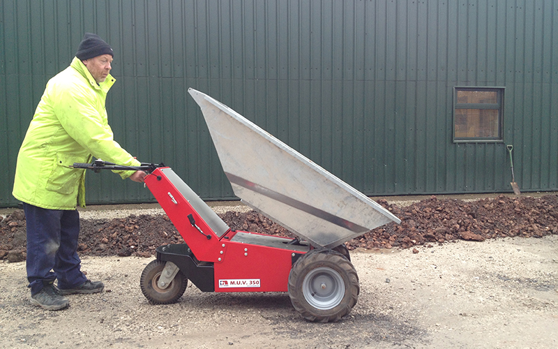 Electric Wheelbarrow with galvanised steel tub to show electric tip operation Electric Wheelbarrow with galvanised steel tub to show electric tip operation