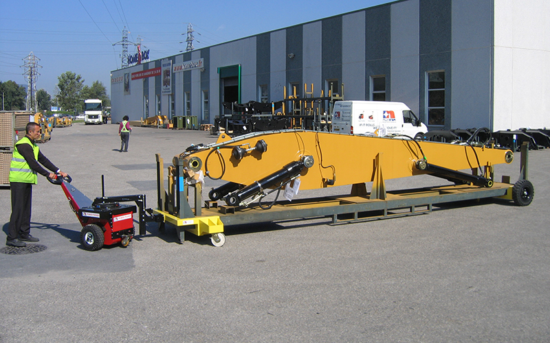 Power Pusher, with Steering Arm attachment, moving 3,500Kg excavator boom on mobile stillage Power Pusher, with Steering Arm attachment, moving 3,500Kg excavator boom on mobile stillage