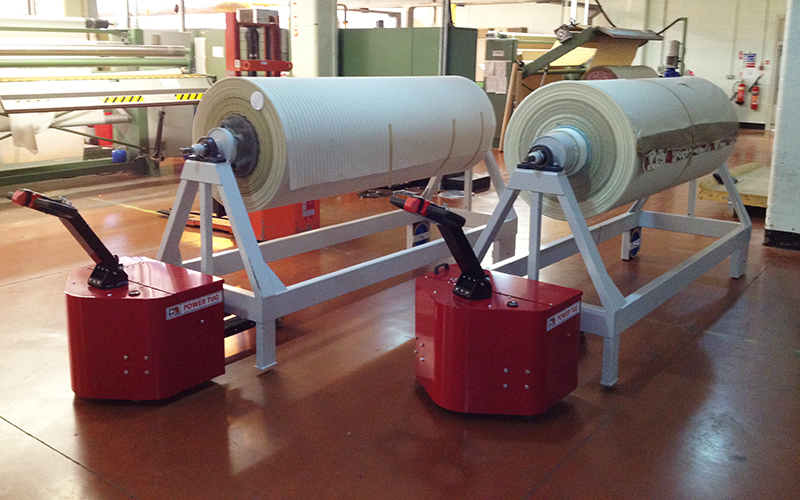 PowerTugs moving 3,500Kg Fabric Roll trolleys. Lifting carriage on PowerTug negates absence of castors at front of trolleys PowerTugs moving 3,500Kg Fabric Roll trolleys. Lifting carriage on PowerTug negates absence of castors at front of trolleys